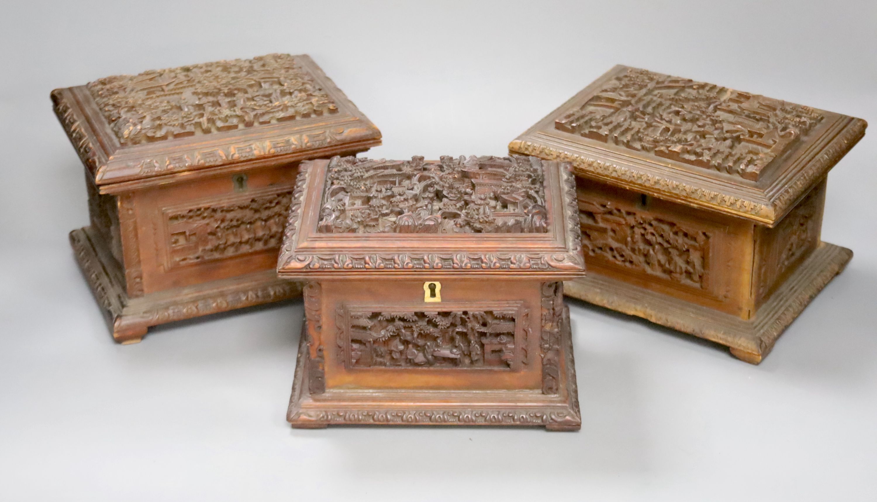 Three Chinese carved hardwood caskets, largest 19 x 15cm 13cm high